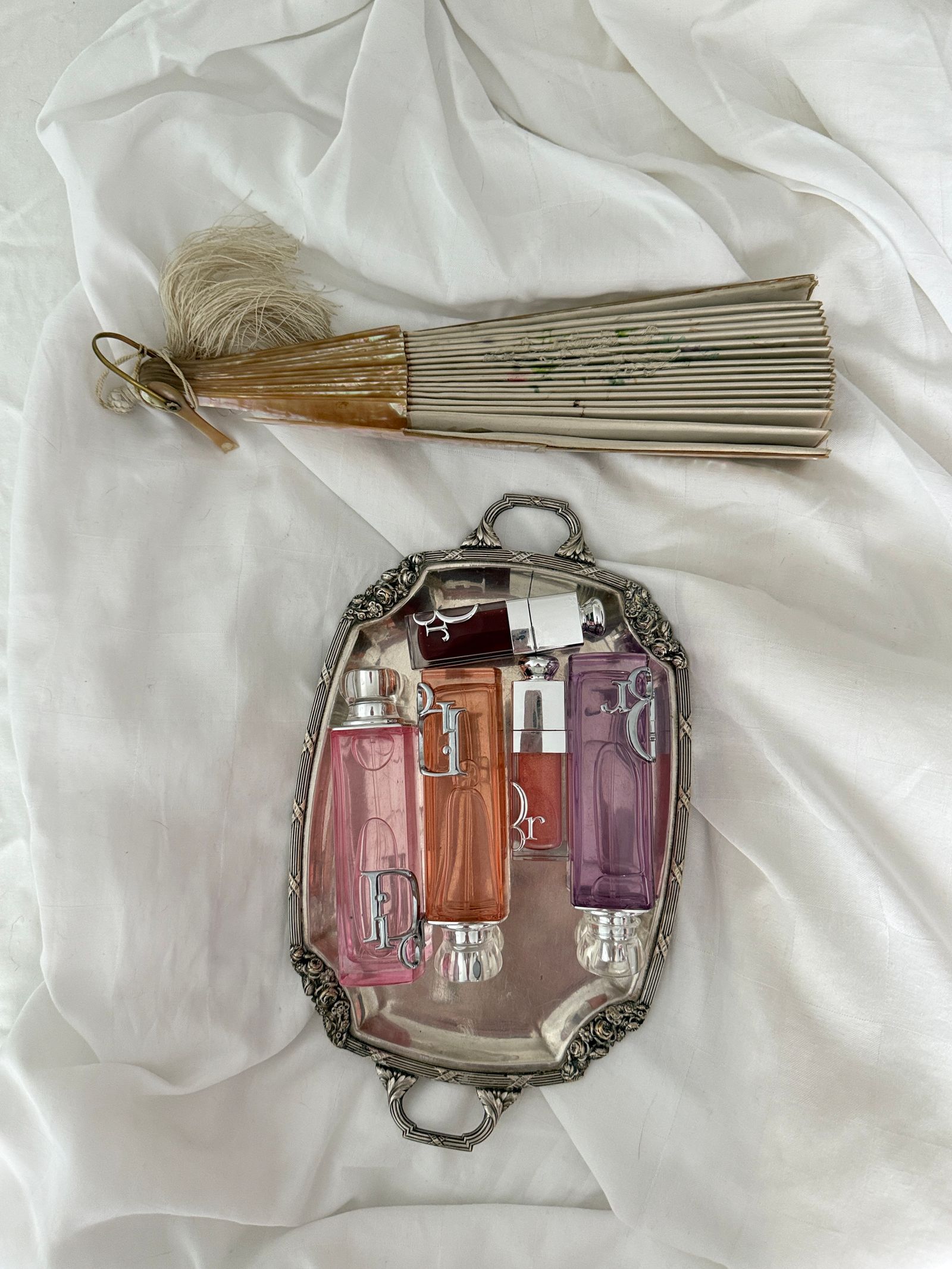 A seller holding a boxed fragrance, dressed with care